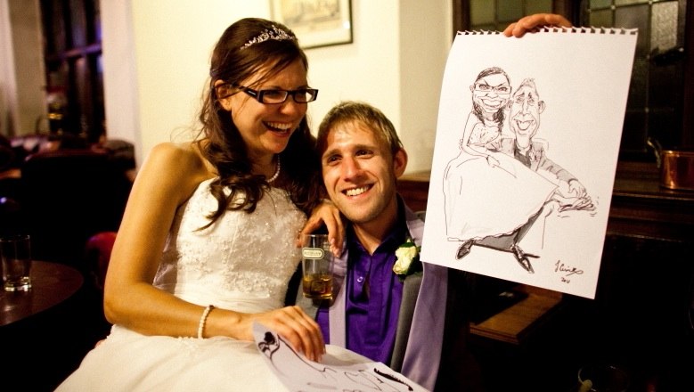 Previous customers with caricature of their wedding day